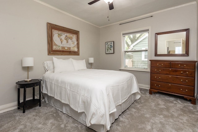 carpeted bedroom with ceiling fan and ornamental molding