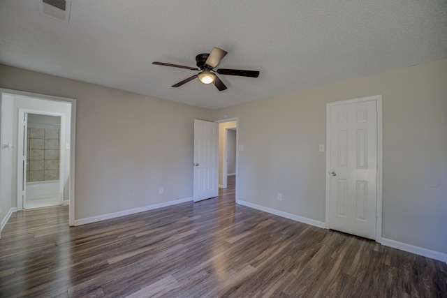 empty room featuring ceiling fan, dark hardwood / wood-style floors, and a textured ceiling