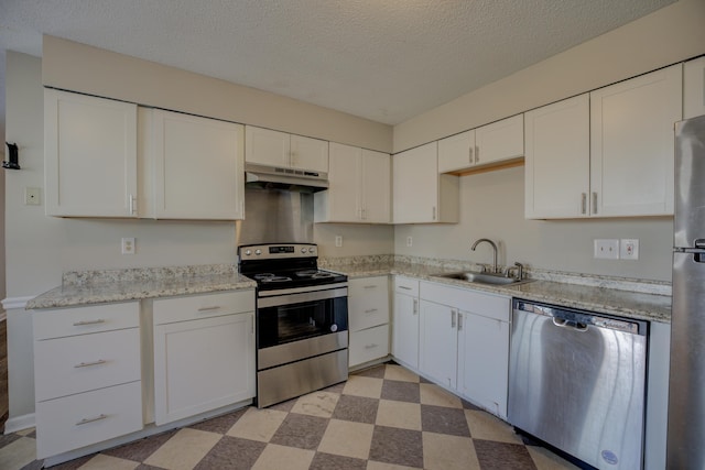 kitchen with sink, a textured ceiling, white cabinets, and appliances with stainless steel finishes