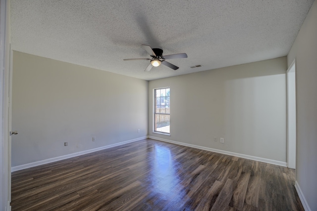 spare room with dark hardwood / wood-style flooring, a textured ceiling, and ceiling fan