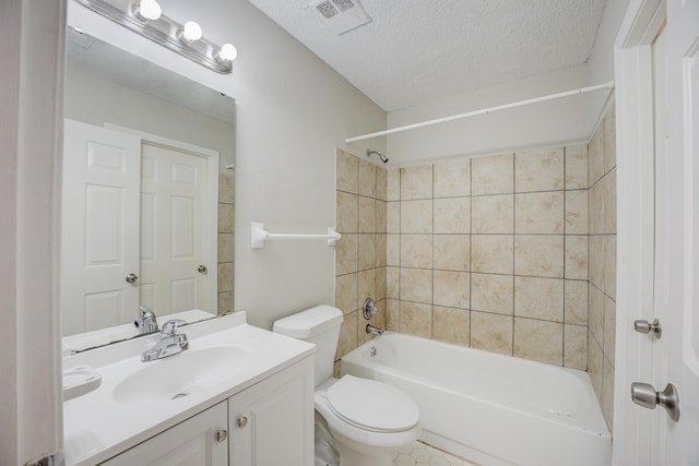 full bathroom featuring tiled shower / bath combo, vanity, a textured ceiling, and toilet