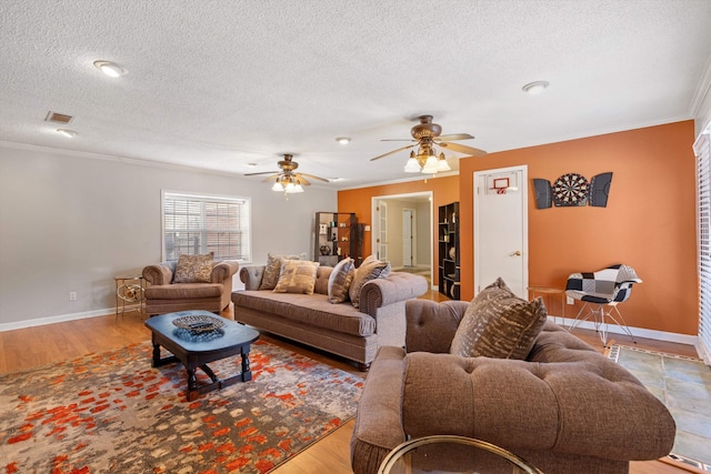 living room with crown molding, a textured ceiling, and light hardwood / wood-style flooring