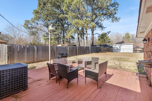 wooden terrace featuring area for grilling, central AC unit, and a lawn