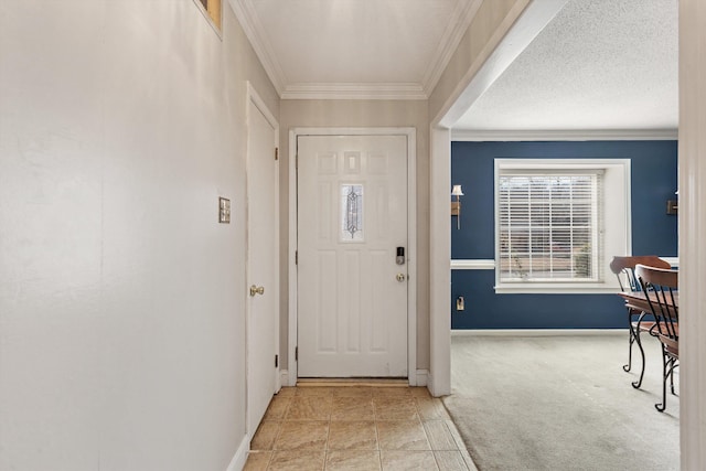 foyer featuring ornamental molding, light carpet, and a textured ceiling