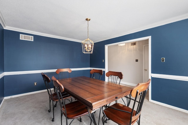 dining room featuring crown molding, a chandelier, and carpet flooring