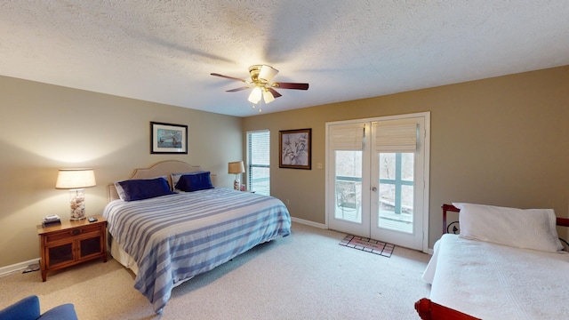 carpeted bedroom featuring access to outside, a textured ceiling, ceiling fan, and french doors