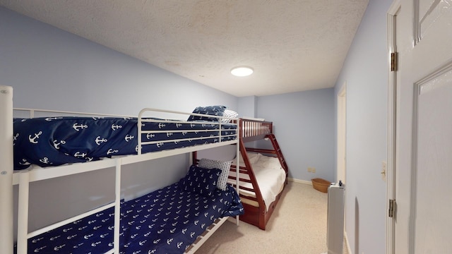 carpeted bedroom with a textured ceiling