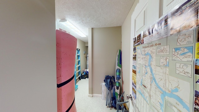 hallway with a textured ceiling