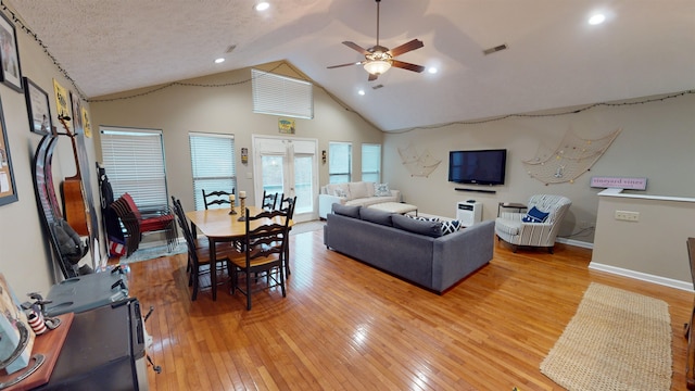 living room featuring hardwood / wood-style flooring, high vaulted ceiling, and ceiling fan