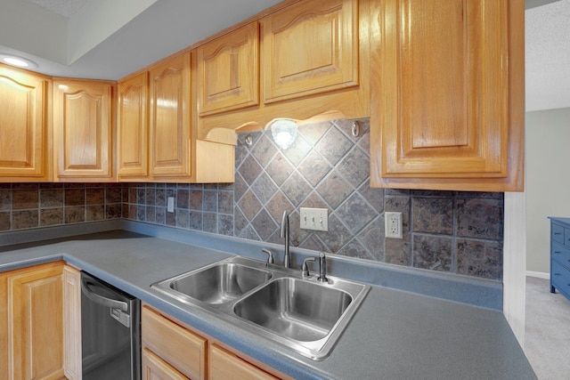 kitchen featuring tasteful backsplash, dishwasher, and sink