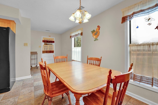 dining space featuring an inviting chandelier