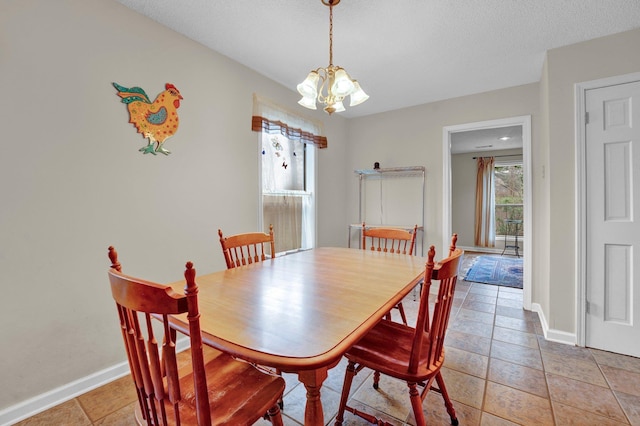 dining room featuring plenty of natural light, a notable chandelier, and a textured ceiling