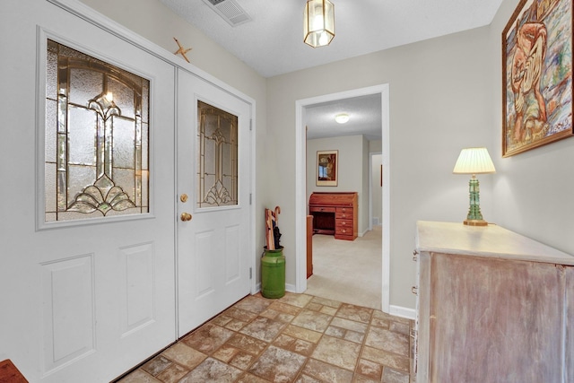 foyer with light carpet and french doors