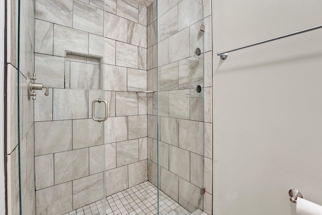 bathroom featuring a shower with door