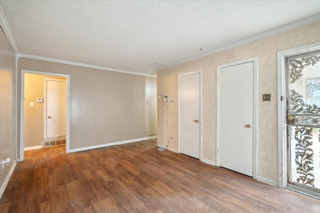 unfurnished bedroom with crown molding, dark hardwood / wood-style floors, and a textured ceiling