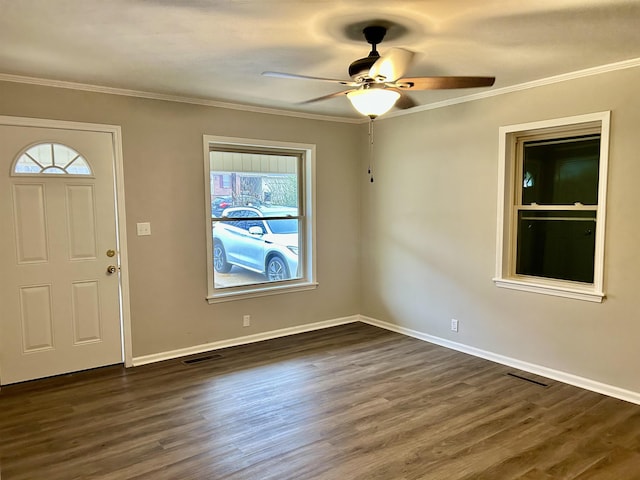 foyer entrance with ornamental molding, dark hardwood / wood-style floors, and ceiling fan