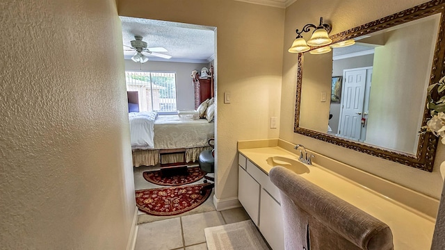 bathroom featuring vanity, crown molding, and a textured ceiling