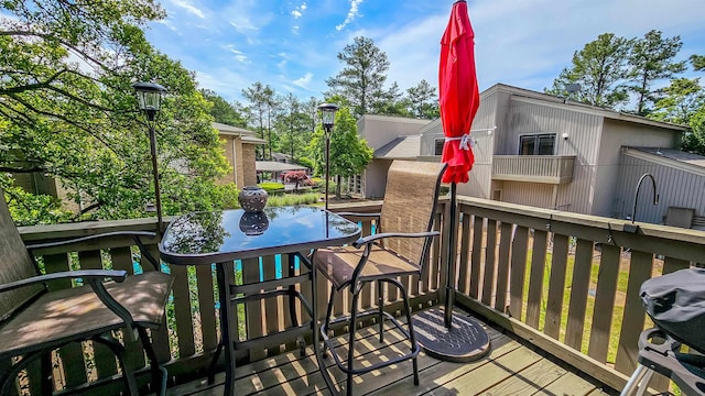 wooden balcony featuring area for grilling and a deck