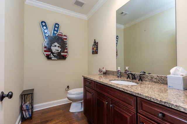 bathroom with hardwood / wood-style flooring, ornamental molding, vanity, and toilet