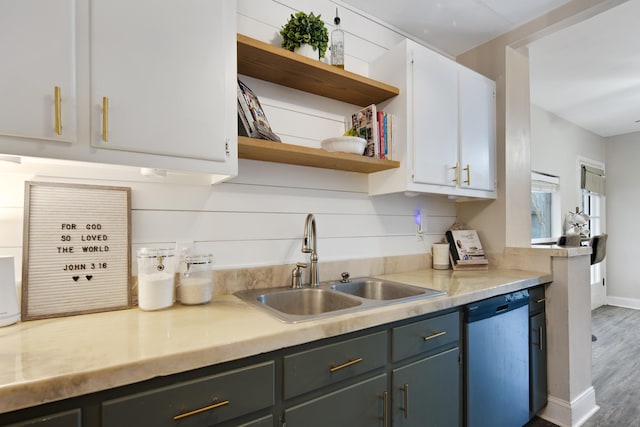 kitchen with white cabinetry, stainless steel dishwasher, dark hardwood / wood-style floors, and sink