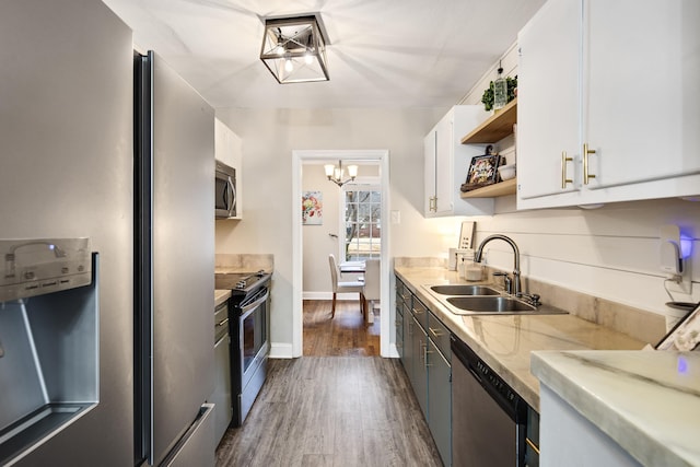 kitchen featuring sink, white cabinetry, a chandelier, dark hardwood / wood-style floors, and stainless steel appliances