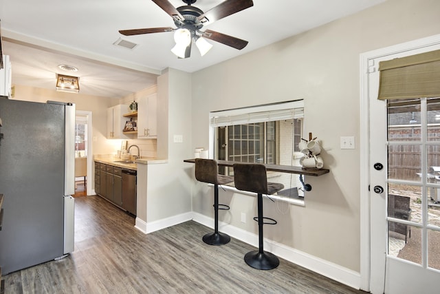 kitchen with sink, dark hardwood / wood-style floors, ceiling fan, and appliances with stainless steel finishes