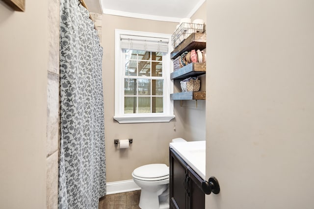 bathroom featuring vanity, hardwood / wood-style floors, crown molding, and toilet