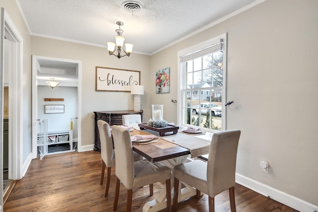 dining room featuring dark hardwood / wood-style flooring, a notable chandelier, ornamental molding, and a textured ceiling