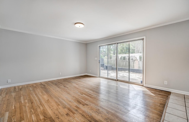 empty room with light hardwood / wood-style flooring and ornamental molding