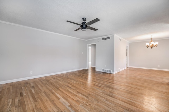 unfurnished room with ceiling fan with notable chandelier, ornamental molding, light hardwood / wood-style floors, and a textured ceiling