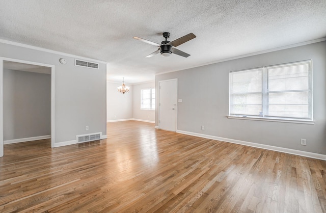 unfurnished room with crown molding, wood-type flooring, ceiling fan with notable chandelier, and a textured ceiling