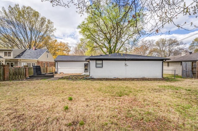 rear view of property with a lawn