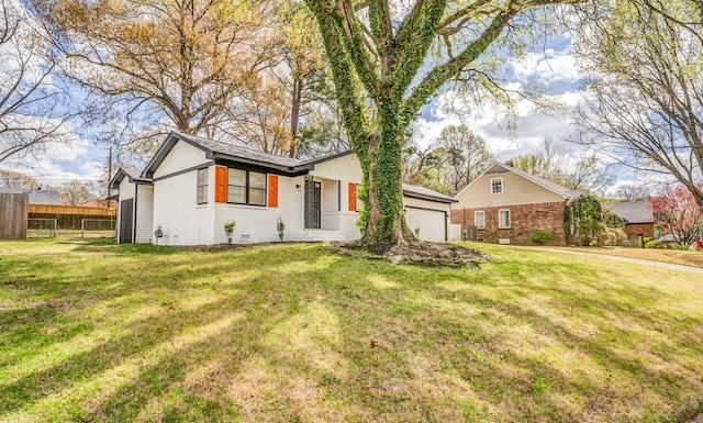 ranch-style home featuring a garage and a front yard