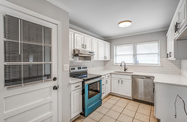 kitchen with appliances with stainless steel finishes, tasteful backsplash, sink, white cabinets, and ornamental molding