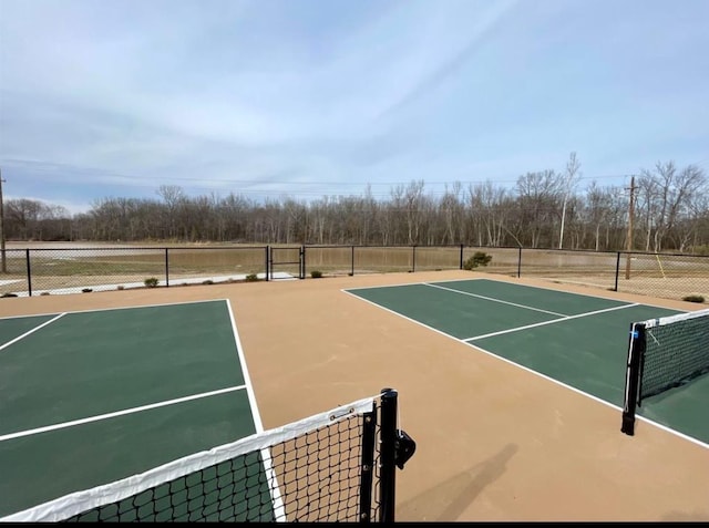 view of tennis court with basketball hoop