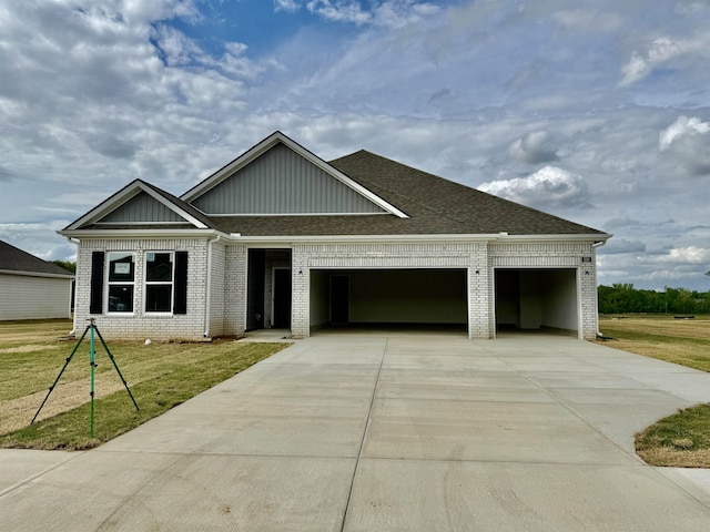 230 Oak Hollow Dr, Oakland, TN 38060 - view of front facade with driveway, roof with shingles, a front yard, a garage, and brick siding