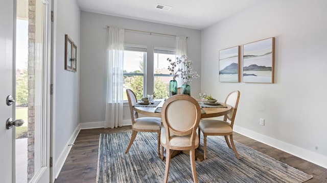 dining space with dark hardwood / wood-style floors