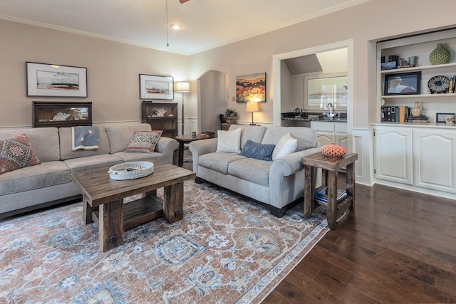 living room featuring crown molding, dark hardwood / wood-style floors, and sink