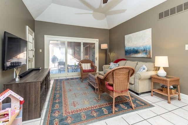 tiled living room with lofted ceiling and ceiling fan