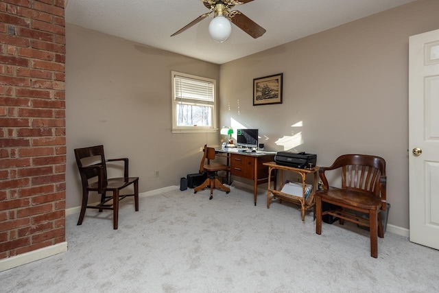 office space featuring light carpet and ceiling fan