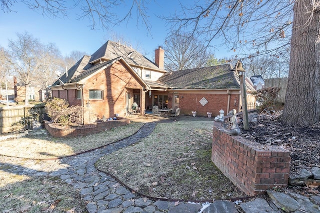 back of property featuring a patio and a lawn