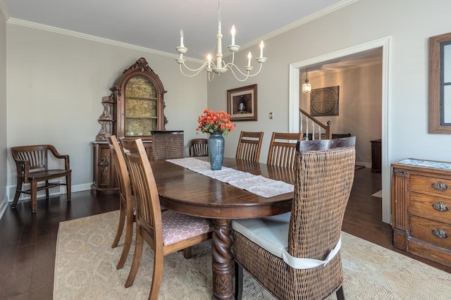 dining room with crown molding, dark hardwood / wood-style floors, and a notable chandelier