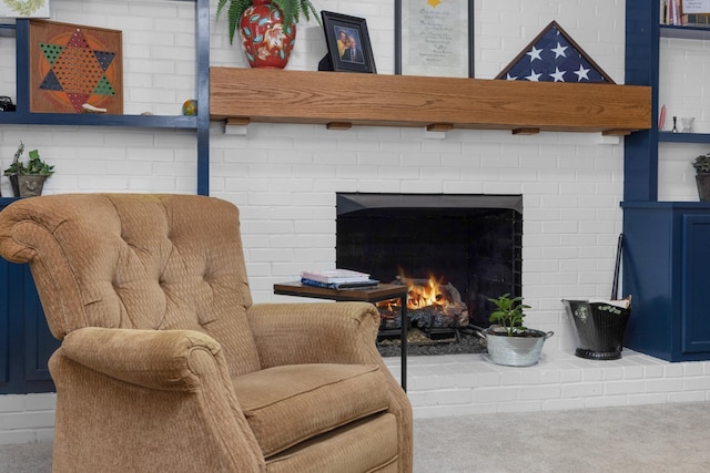 living area with a fireplace and carpet