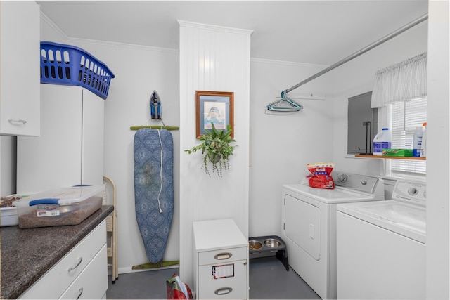 laundry area featuring ornamental molding, cabinets, and washing machine and clothes dryer