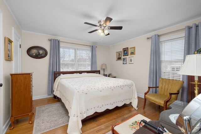 bedroom featuring hardwood / wood-style flooring, ornamental molding, and ceiling fan