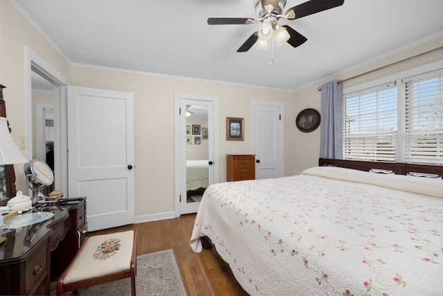 bedroom with crown molding, ceiling fan, dark wood-type flooring, and ensuite bath