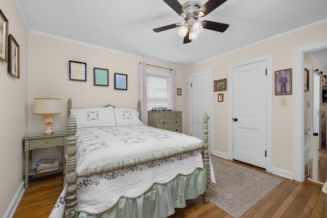 bedroom featuring crown molding, hardwood / wood-style flooring, and ceiling fan