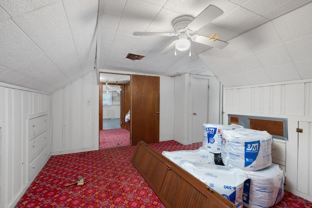 additional living space with vaulted ceiling, carpet, and ceiling fan