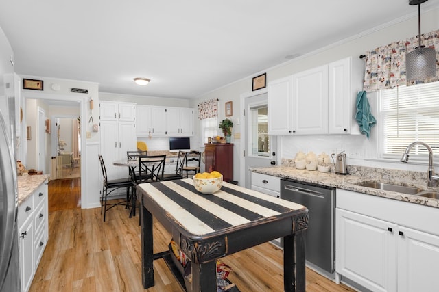 kitchen with sink, dishwasher, white cabinetry, light stone countertops, and decorative light fixtures