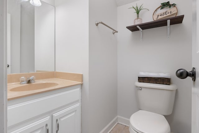 bathroom featuring tile patterned flooring, vanity, and toilet